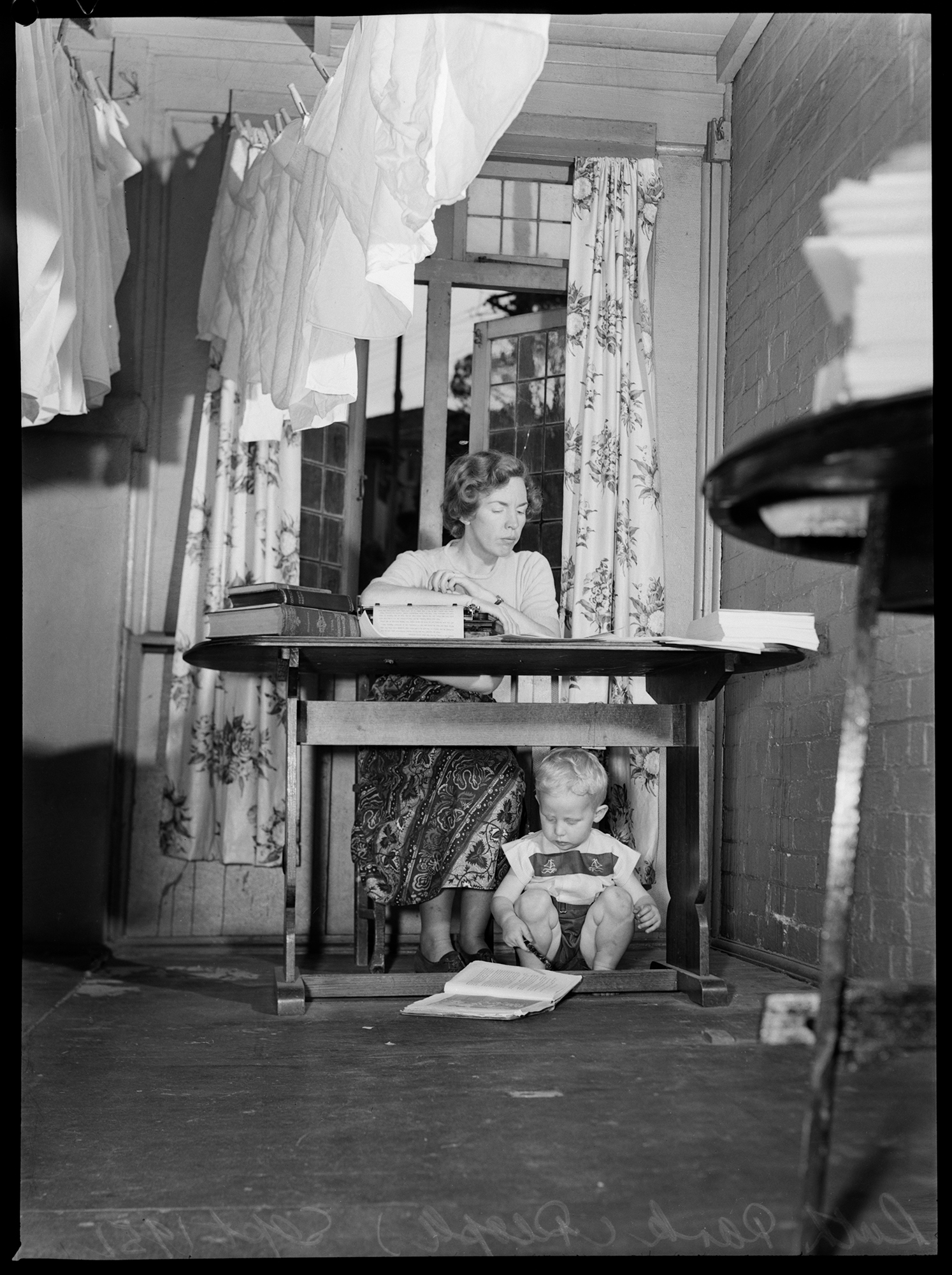 ruth-park-writing-at-home-one-of-her-children-under-the-table